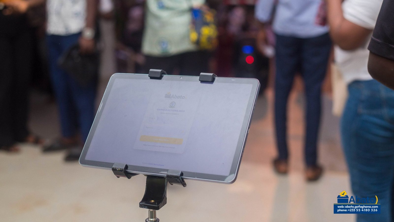 An Abato voter authentication screen displayed on a tablet stand.