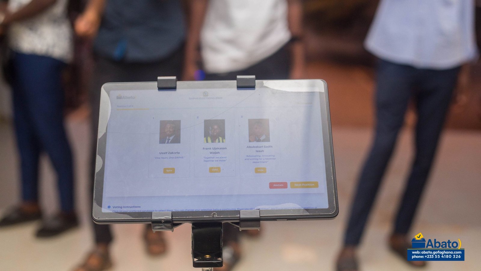 A tablet displaying the digital ballot and candidate options.