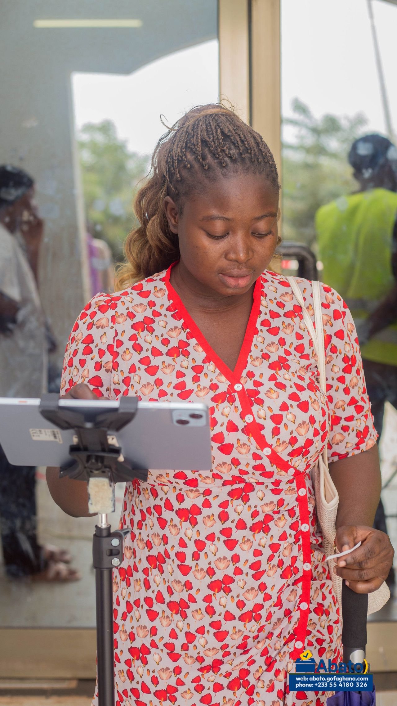A student interacting with a tablet voting station.