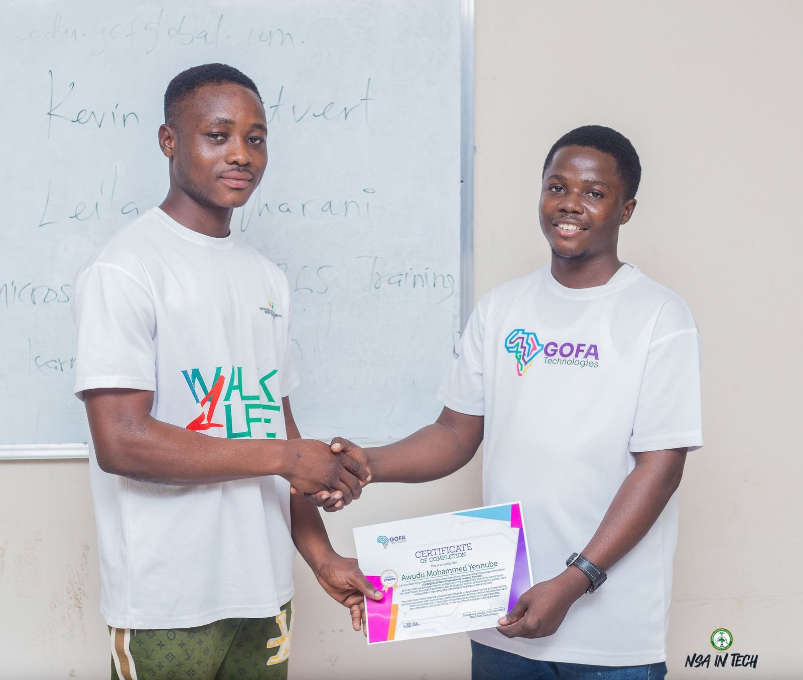A participant and a GOFA team member holding a completion certificate.