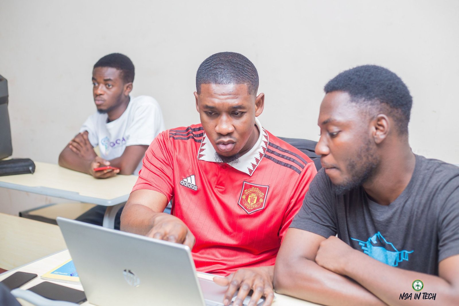 Two participants working together at a laptop during training.