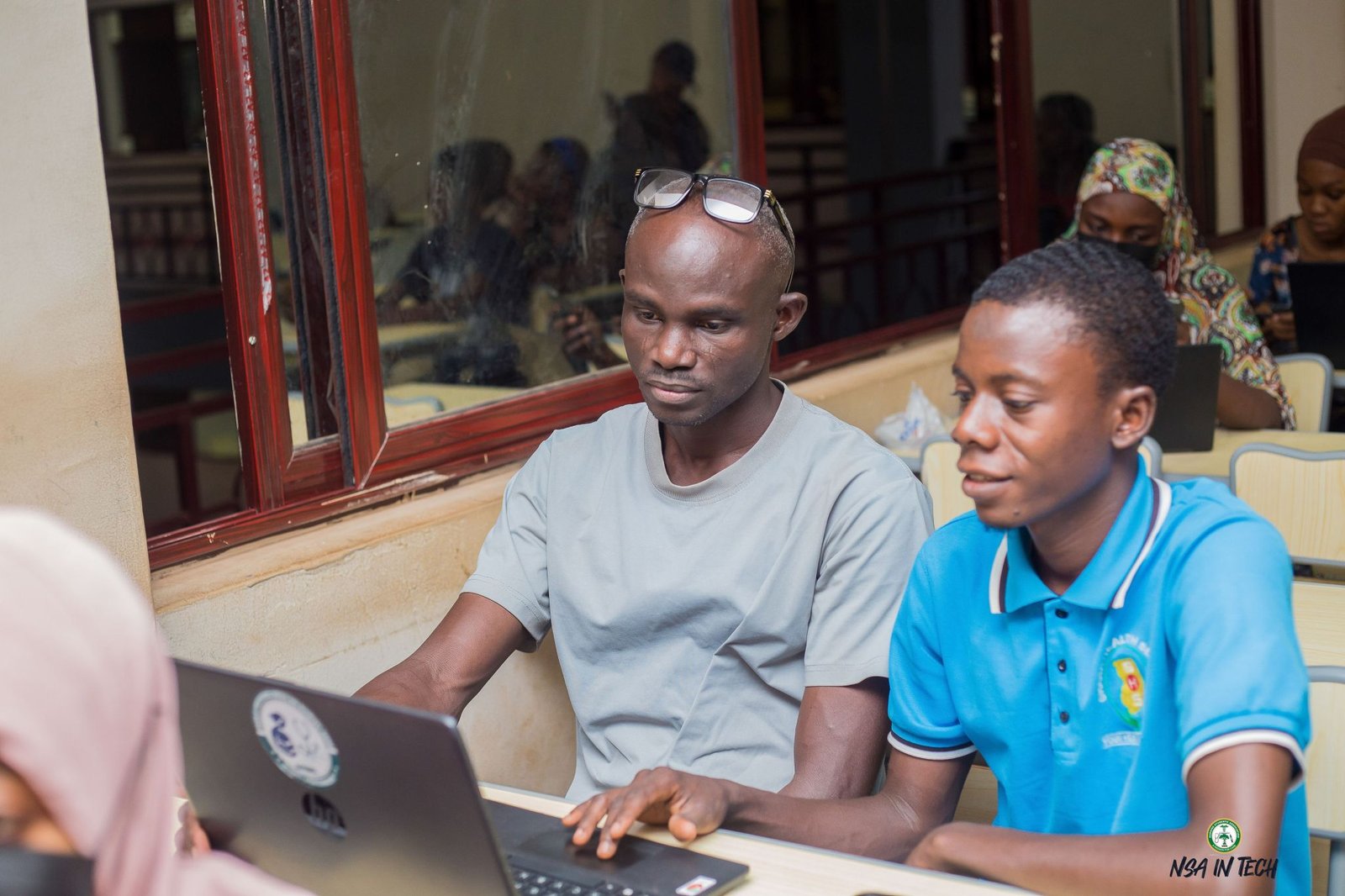 Participants following a training activity on a laptop.