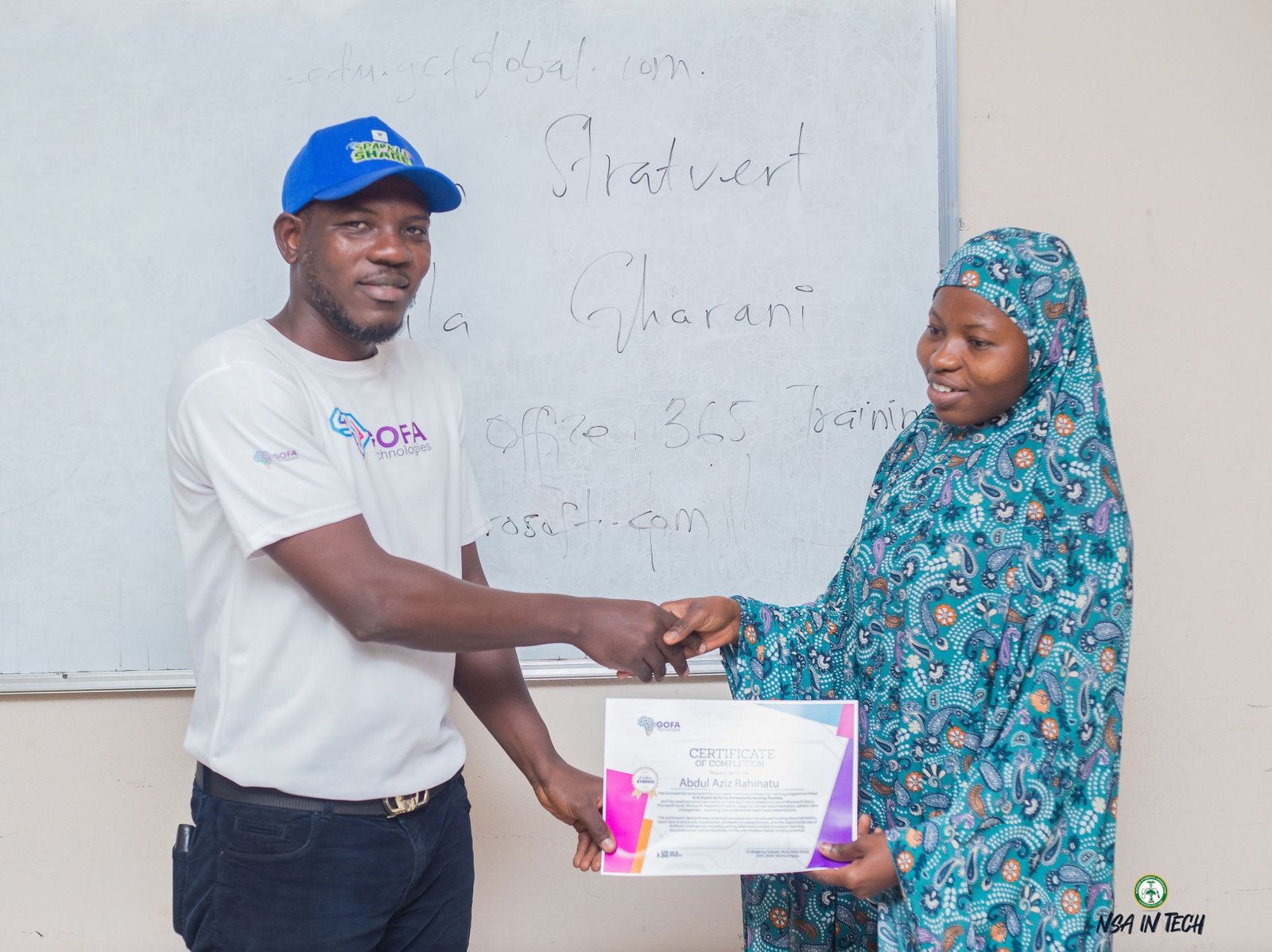 A participant receiving a completion certificate in the classroom.